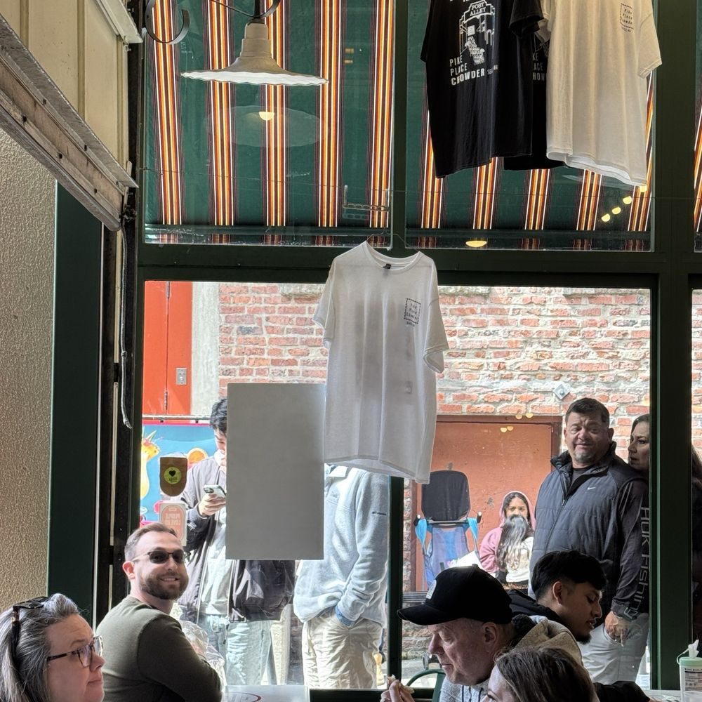 Pike Place Chowder - The hubby at our little table happy as a literal clam. Line behind him. - Seafood Near Me - Seattle, Washington Pike Place Chowder - The hubby at our little table happy as a literal clam. Line behind him. - Seafood Near Me - Seattle, Washington
