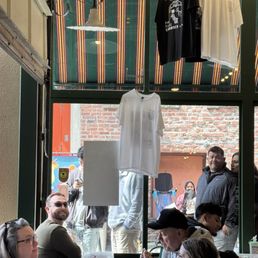 The hubby at our little table happy as a literal clam. Line behind him.