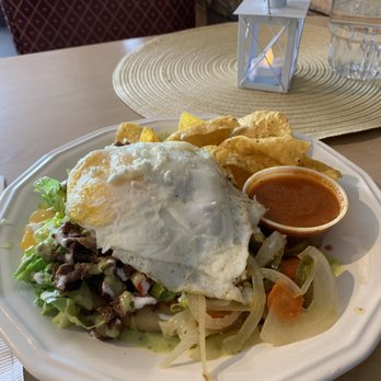 Mochileros Street Food - Mountain pupusa- a giant pupusa topped with your choice of carne asada, chicken or reindeer, an egg, signature sauce and relished onions. - Food Trucks Near Me - Anchorage, Alaska