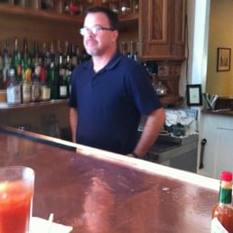 Grumpy bartender at American hotel.