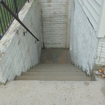 Dirtyware Pressure Washing - basement stairwell after (dark spots are bare concrete where paint is missing) - Pressure Washers Near Me