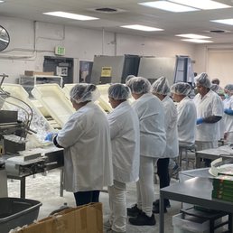Workers packaging aplets & cotlets by hand Workers packaging aplets & cotlets by hand