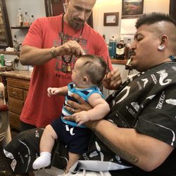 Anthony giving my 3 month old son his first haircut.