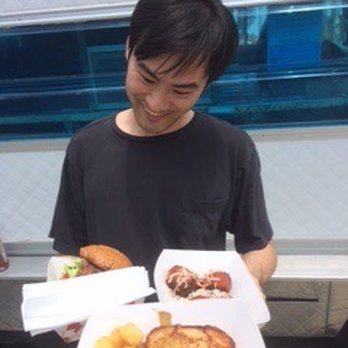 Tastebuds - a man holding a tray of food - Food Trucks Near Me Tastebuds - a man holding a tray of food - Food Trucks Near Me