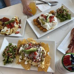 Chilaquiles, cowboy carnitas, Mexican folded eggs, side of bacon, parfait Chilaquiles, cowboy carnitas, Mexican folded eggs, side of bacon, parfait