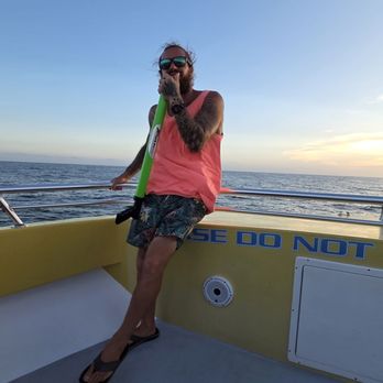 AJ's Water Adventures - One of our captains engaging with everyone on the boat - Boat Charters Near Me - Destin, Florida AJ's Water Adventures - One of our captains engaging with everyone on the boat - Boat Charters Near Me - Destin, Florida