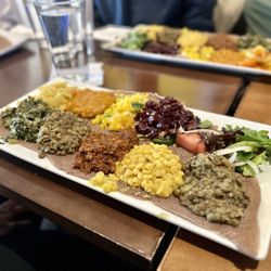 Chercher Ethiopian Restaurant and Bar - Checher Vegan Deluxe - an assortment of vegetable stews, include peas, lentils, collard greens, carrots, and more, served atop injera