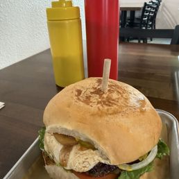 Burger with goat cheese, grilled garlic, lettuce, tomatoes, pickles, onions.