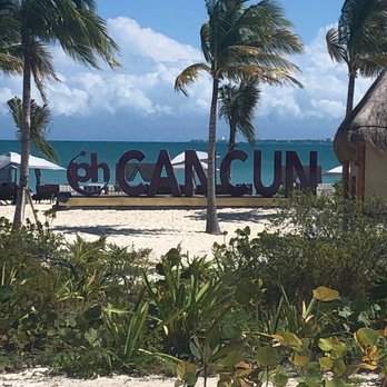 Your Passport to Travel - The beach at Planet Hollywood Cancun - Travel Agents Near Me