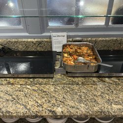 Empty food services with unstocked serving trays and and beverage dispensers