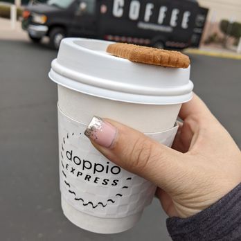 Doppio Express - a hand holding a coffee cup - Caterers Near Me