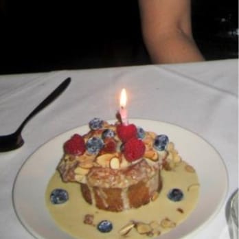Salum Restaurant - Bourbon Bread pudding, Creme Anglaise, Toasted Almonds - birthday style. - New American Near Me - Dallas, Texas Salum Restaurant - Bourbon Bread pudding, Creme Anglaise, Toasted Almonds - birthday style. - New American Near Me - Dallas, Texas
