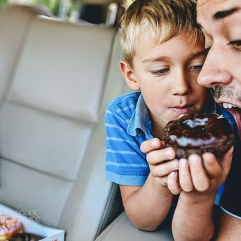 Dunkin' - a father and son eating a chocolate donut - Donuts Near Me - Brookfield, Illinois Dunkin' - a father and son eating a chocolate donut - Donuts Near Me - Brookfield, Illinois