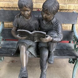 Jen's Books - An adorable statue out front of two children reading Tarzan