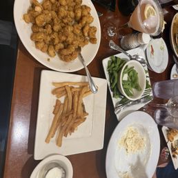 In this picture is fire cracker shrimp Alfredo french fries and a martini. In this picture is fire cracker shrimp Alfredo french fries and a martini.
