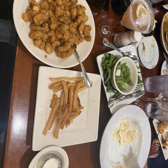 Cosmo's Restaurant & Bar - In this picture is fire cracker shrimp Alfredo french fries and a martini. - New American Near Me - Orange Beach, Alabama Cosmo's Restaurant & Bar - In this picture is fire cracker shrimp Alfredo french fries and a martini. - New American Near Me - Orange Beach, Alabama