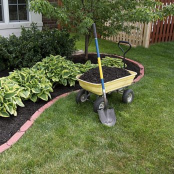 Solt’s Services - a wheelbarrow in a garden - Lawn Services Near Me