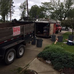 a garbage truck parked in front of a house