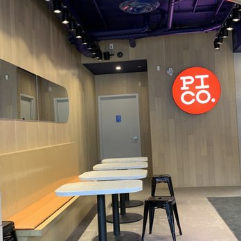 Pi Co - a table and two chairs in a room - Pizza Near Me - Ottawa, Ontario Pi Co - a table and two chairs in a room - Pizza Near Me - Ottawa, Ontario