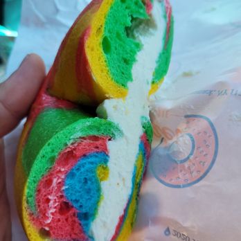 Bagel Toasterie - a person holding a sandwich - Bagels Near Me - Commack, New York