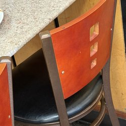 Nori Presto - Dirty table and chair, w flies flying around.
