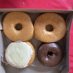 Two glazed, lemon filled and chocolate with chocolate icing.