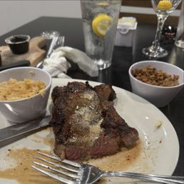 Ribeye with loaded potato casserole and dirty rice. Ribeye with loaded potato casserole and dirty rice.