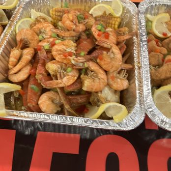 Outta Da Box - two trays of seafood with lemon wedges - Food Trucks Near Me - Houston, Texas Outta Da Box - two trays of seafood with lemon wedges - Food Trucks Near Me - Houston, Texas