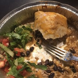 a plate of mexican food with a fork a plate of mexican food with a fork