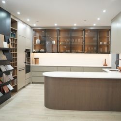 A to Z Renovations - Model kitchen with
- Finger panel kitchen island
- Glass cabinets
- Panel-ready appliances
- Samples of cabinet and countertop finishes