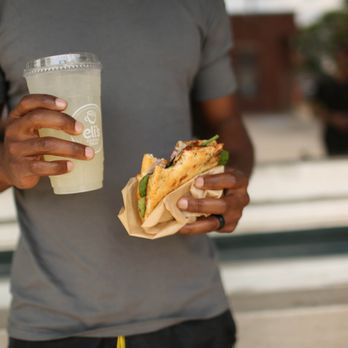 Eli's Coffee Shop - a man holding a drink and a sandwich - Coffee & Tea Near Me - Mackinaw, Illinois Eli's Coffee Shop - a man holding a drink and a sandwich - Coffee & Tea Near Me - Mackinaw, Illinois