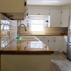 Red River Renovation & Repair - Refaced kitchen cabinets. custom oak countertop, full surround subway tile backsplash
