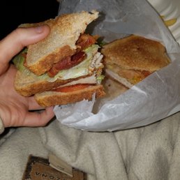a person holding a sandwich