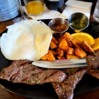 Tiffany's On Broadway - Skirt steak served with your style of eggs, roasted red potatoes, and a citrus twist - Breakfast & Brunch Near Me - Chicago, Illinois Tiffany's On Broadway - Skirt steak served with your style of eggs, roasted red potatoes, and a citrus twist - Breakfast & Brunch Near Me - Chicago, Illinois
