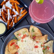 Photo of Wood-n-Tap Bar & Grill- Hartford - Hartford, CT, United States. Crab dip and Tap Room Fries, cosmopolitan