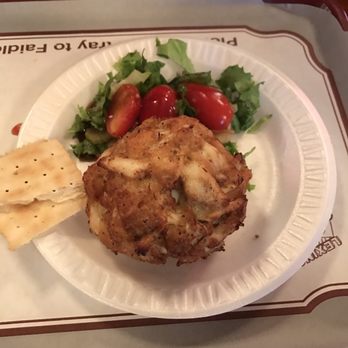 Faidley's Seafood - Single crab cake wi/salad garnish - Seafood Markets Near Me - Baltimore, Maryland