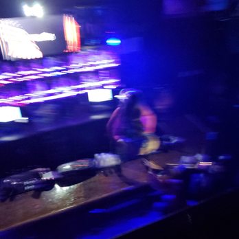 Crow & Company - a man sitting at a bar - Sports Bars Near Me - Orlando, Florida