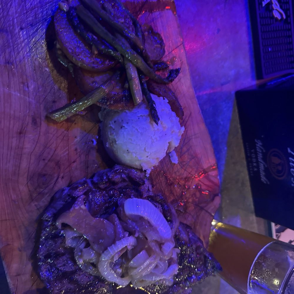 The Blu Moon Bistro - The ribeye with mushrooms and onions - New American Near Me - Ludington, Michigan