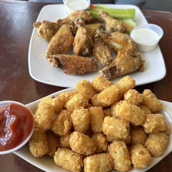 Offshore Tavern & Grill - Lemon & pepper chicken wings with a side of tater tots. - Sports Bars Near Me - San Diego, California Offshore Tavern & Grill - Lemon & pepper chicken wings with a side of tater tots. - Sports Bars Near Me - San Diego, California