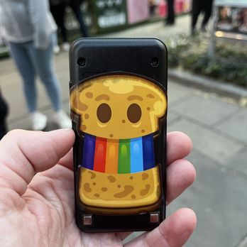 Toastie Land - a person holding a cell phone - Food Stands Near Me - New York, New York Toastie Land - a person holding a cell phone - Food Stands Near Me - New York, New York