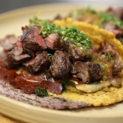 Anepalco - Wagyu beef tacos topped with savory beans, creamy Oaxaca cheese, zesty pico de gallo salsa, and fresh chopped chives.