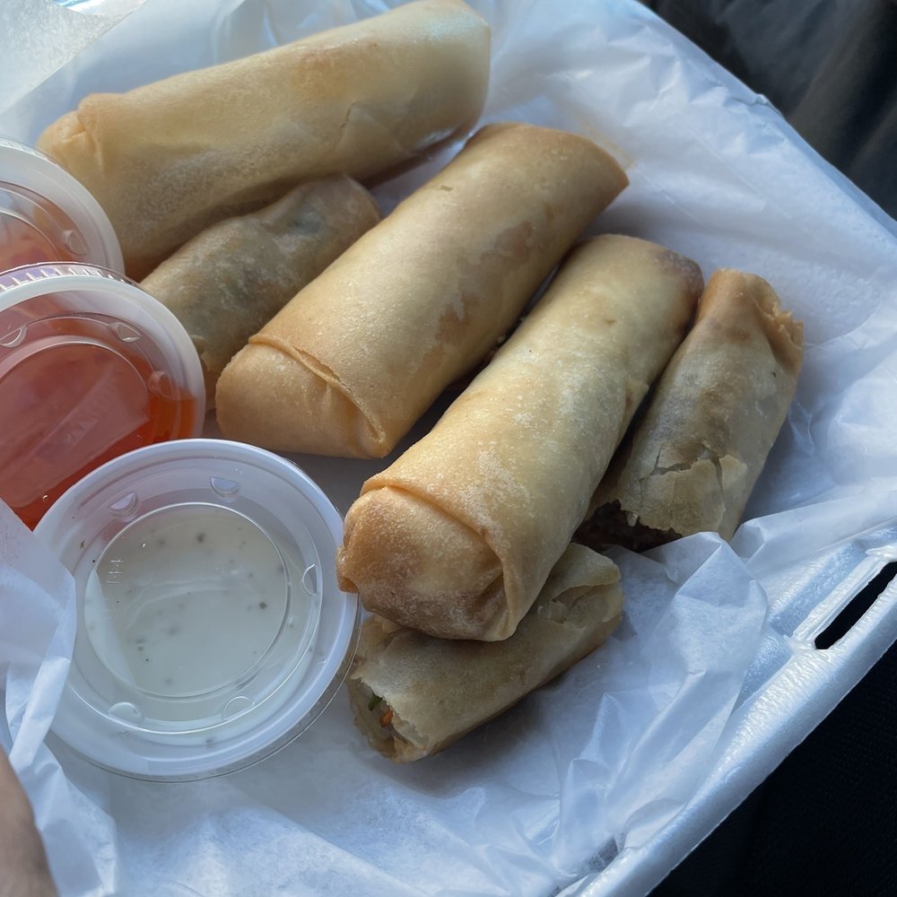 Outlaw Egg Rolls - a person holding a container of ketchup - Asian Fusion Near Me - Lubbock, Texas Outlaw Egg Rolls - a person holding a container of ketchup - Asian Fusion Near Me - Lubbock, Texas