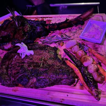Chemistry - a steak and carrots on a cutting board - Steakhouses Near Me - Chicago, Illinois