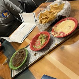 Salsa, queso, and guacamole appetizer. The chips are crispy and great. Salsa, queso, and guacamole appetizer. The chips are crispy and great.