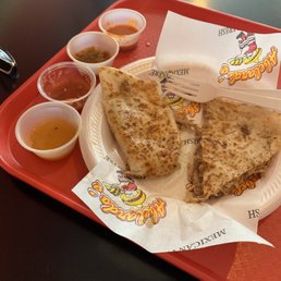 Carnitas quesadilla with delicious hot sauces and salsas.