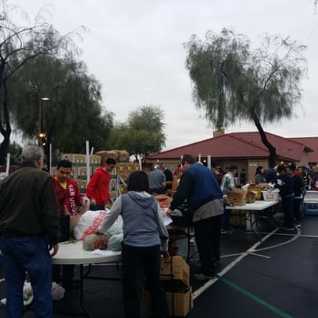 Produce On Wheels - a large group of people standing around a table - Street Vendors Near Me - Chandler, Arizona