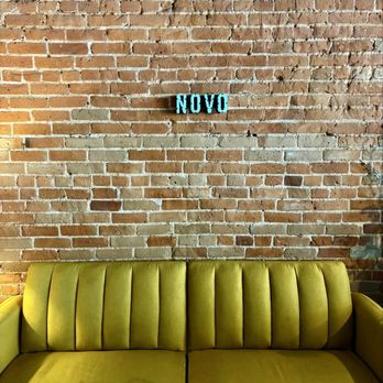 Novo Coffee - Store logo on brick wall; comfy couch - Coffee & Tea Near Me - Denver, Colorado Novo Coffee - Store logo on brick wall; comfy couch - Coffee & Tea Near Me - Denver, Colorado