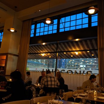 San Morello - The restaurant dining room at dusk. Note that massive windows and upscale but casual atmosphere. - Italian Near Me - Detroit, Michigan San Morello - The restaurant dining room at dusk. Note that massive windows and upscale but casual atmosphere. - Italian Near Me - Detroit, Michigan