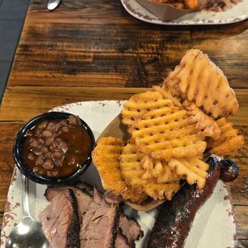Sauced BBQ & Spirits - Two meat combo: brisket, andoullie sausage, baked beans, waffle fries with dry rub - Barbeque Near Me - Irvine, California Sauced BBQ & Spirits - Two meat combo: brisket, andoullie sausage, baked beans, waffle fries with dry rub - Barbeque Near Me - Irvine, California