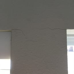 Cracking caused by Blind Faiths poor installation (lack of drilling a starter hole).  The blind on the right side was installed and removed.